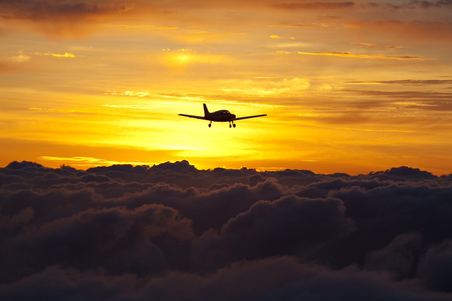 Plane flying through the sky during sunset