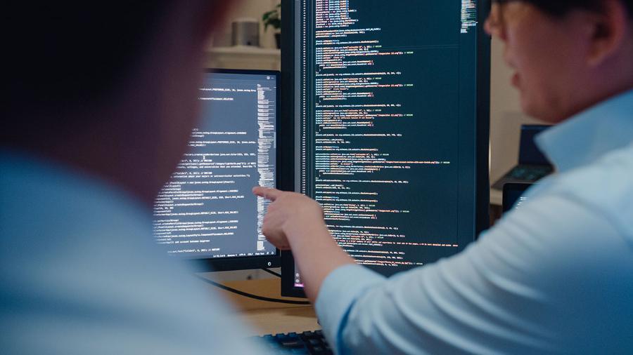 Software developers using computer to write code