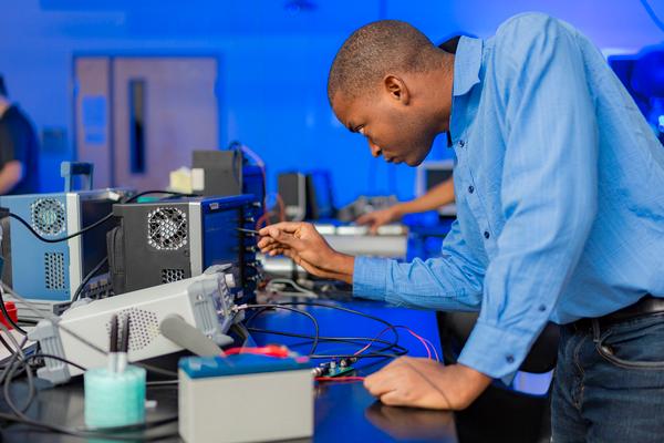 A student researcher adjusts equipment used in lightning research