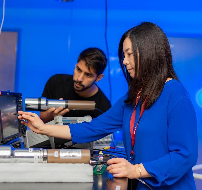 Two students collaborate in a physics research lab