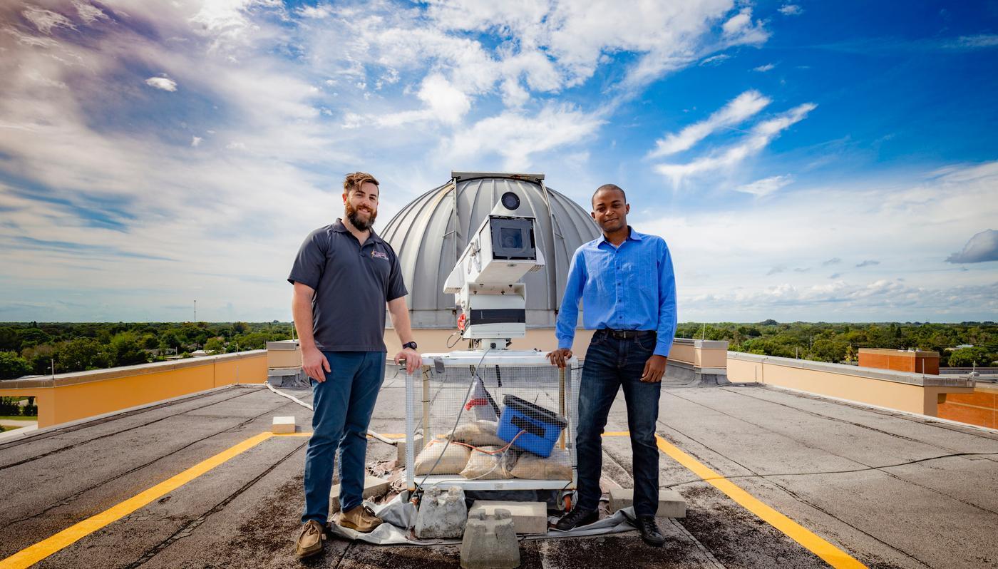 Student researchers setting up a high-speed camera on the roof of the Olin Physical Sciences building to capture images of lightning for research.