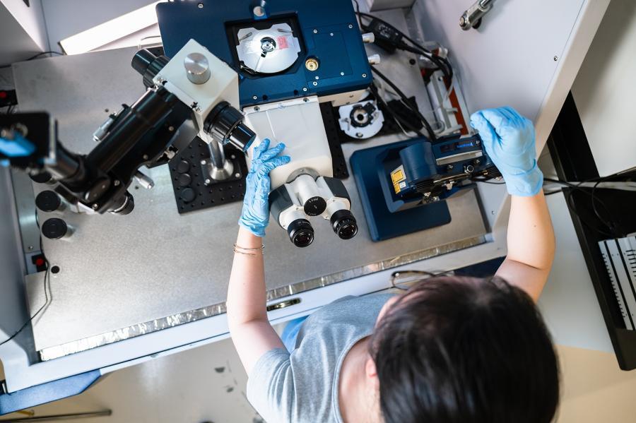 A student works with specialized precision equipment in a biomedical engineering lab.
