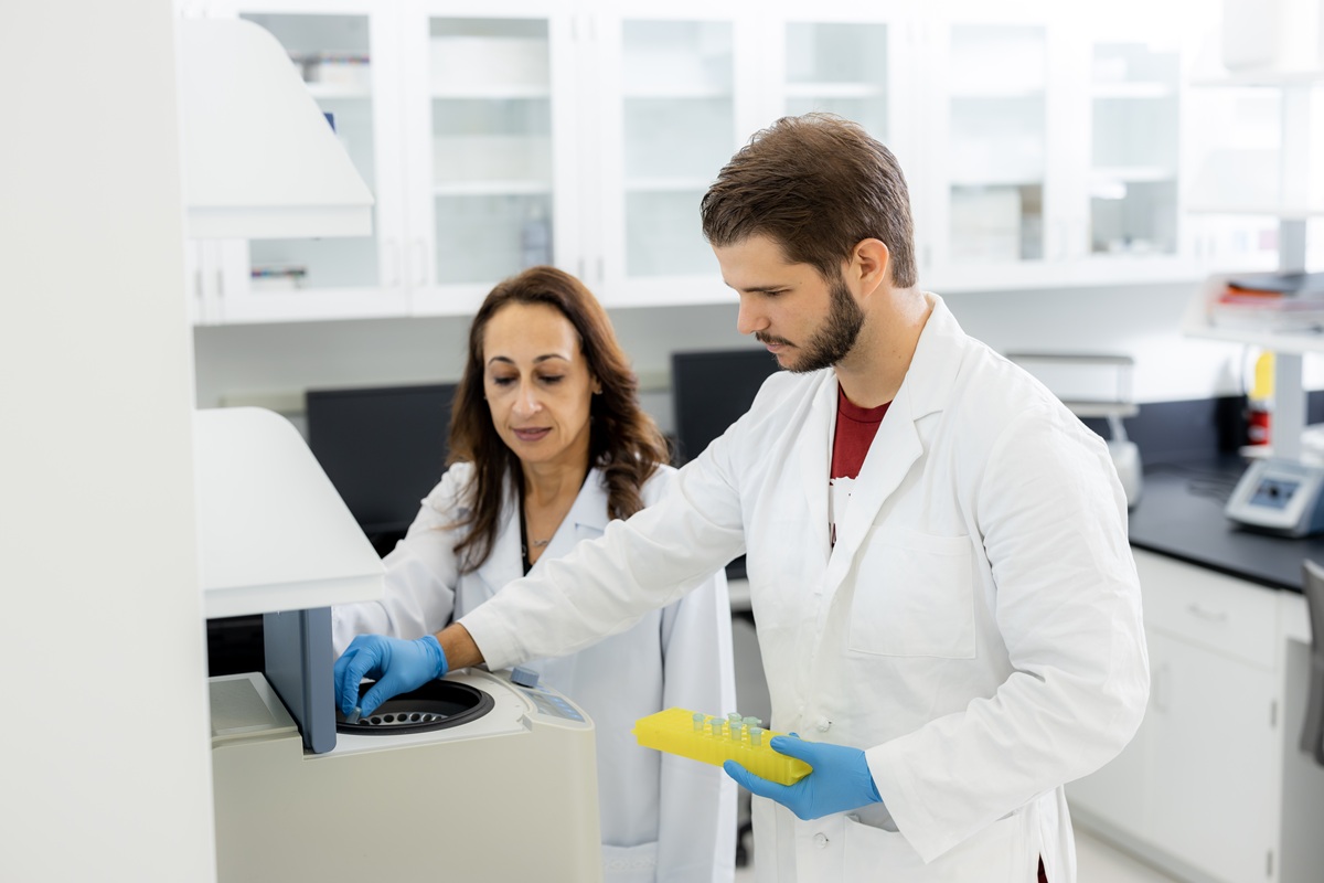 Dr. Nunes and student working with a centrifuge