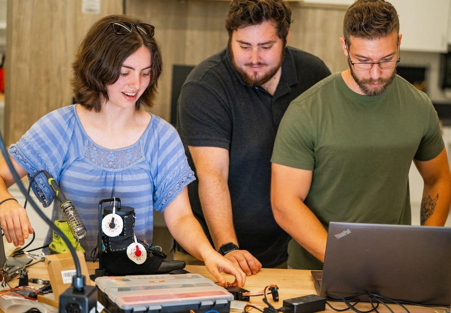 Students working on a wearable technology designed to support the rehabilitation of individuals with Idiopathic Toe Walking.