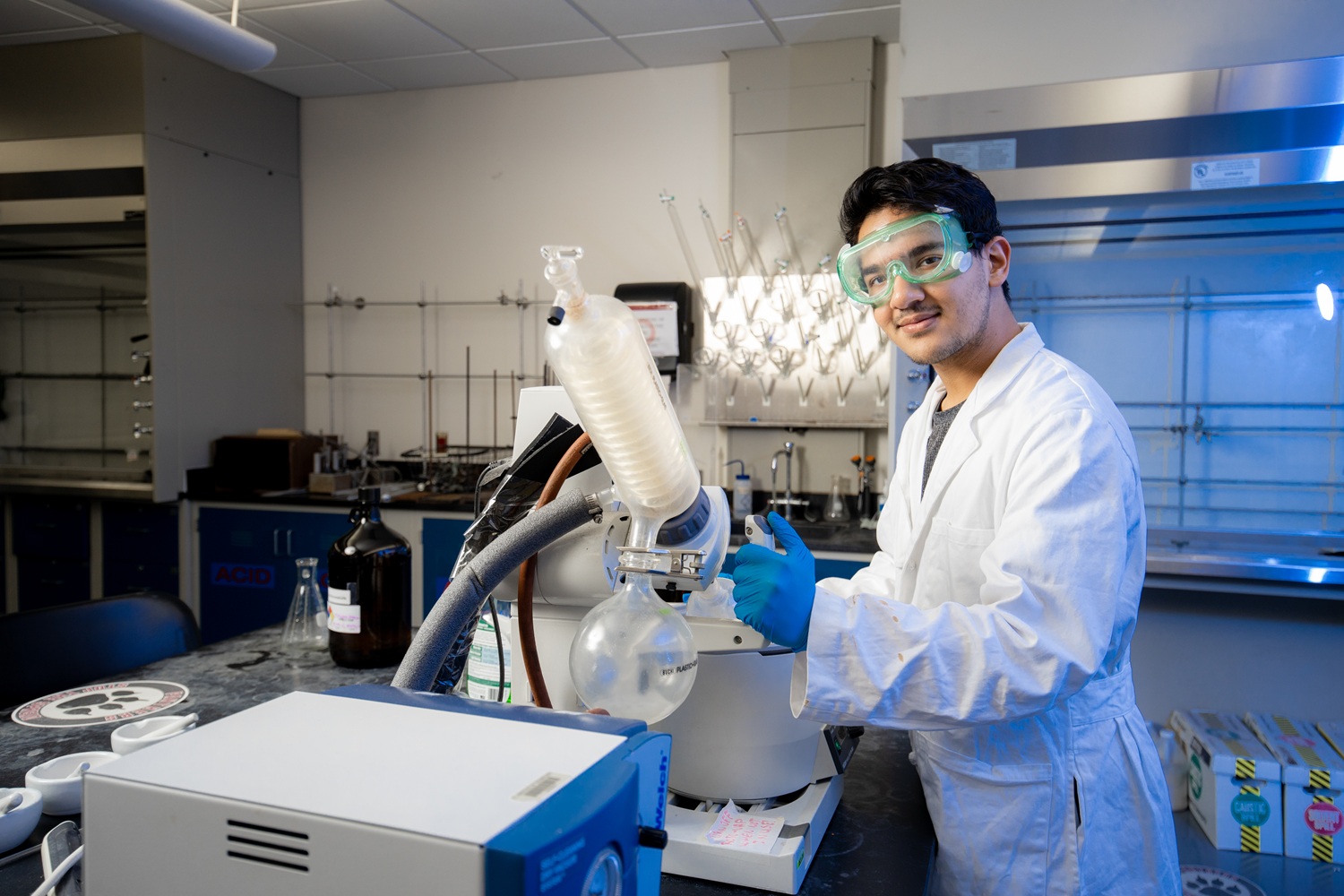 A student using a rotary evaporator in a chemistry lab.
