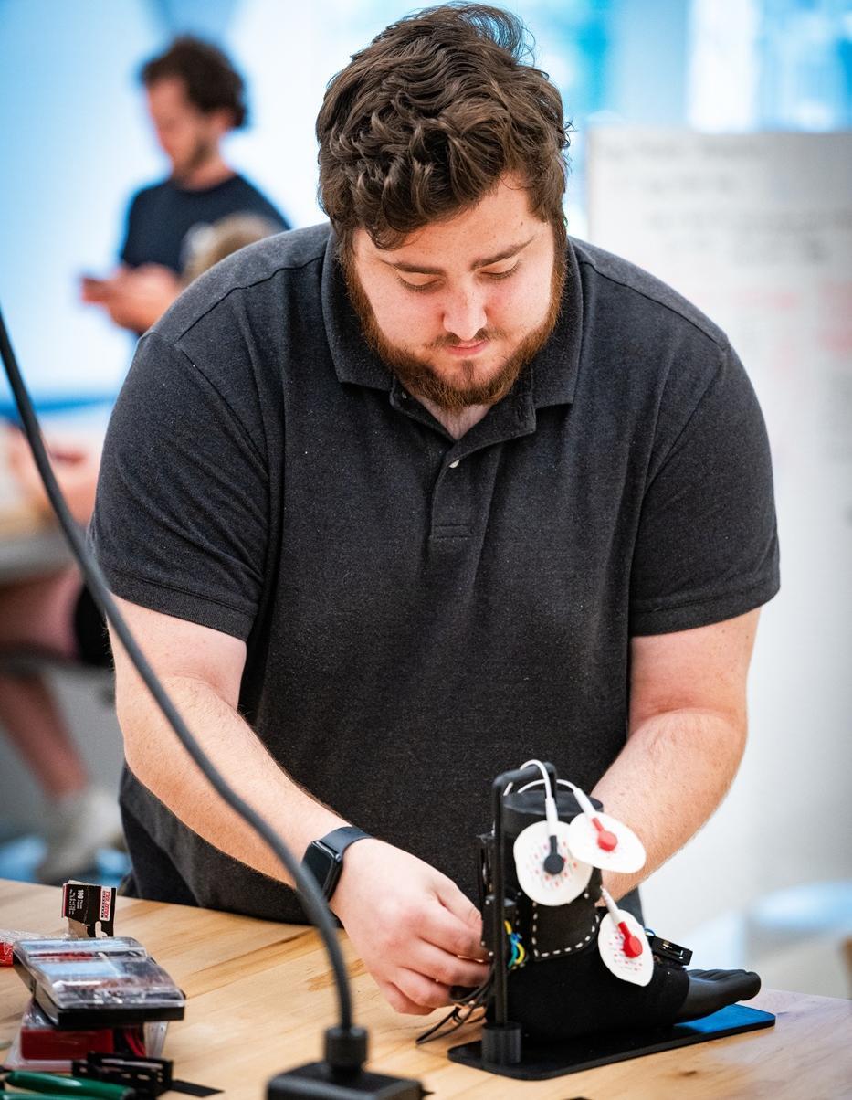 A student works with sensors on a model foot