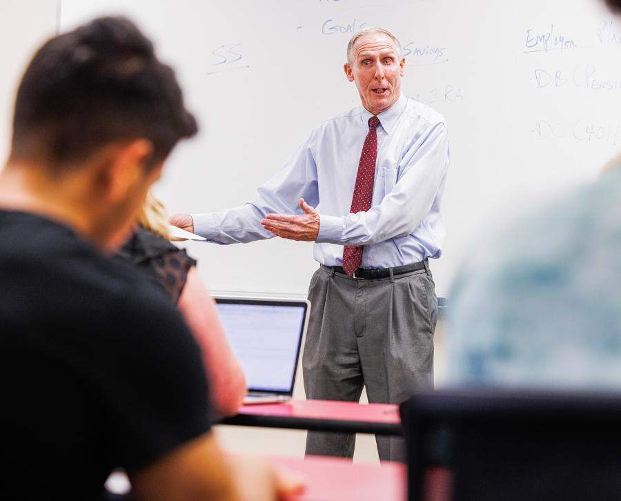 An instructor lecturing at the Bisk College of Business