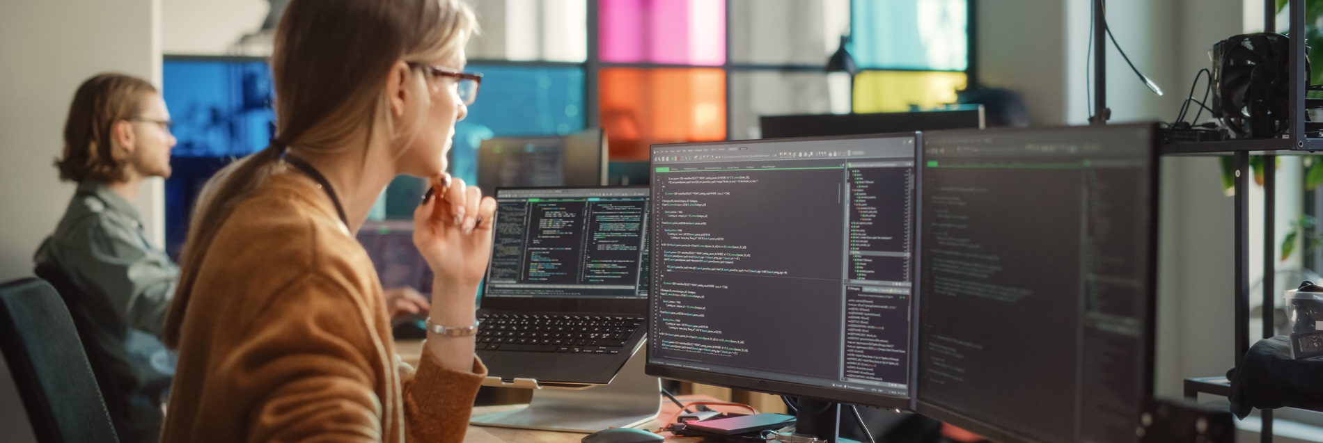 Woman looking at code on a computer