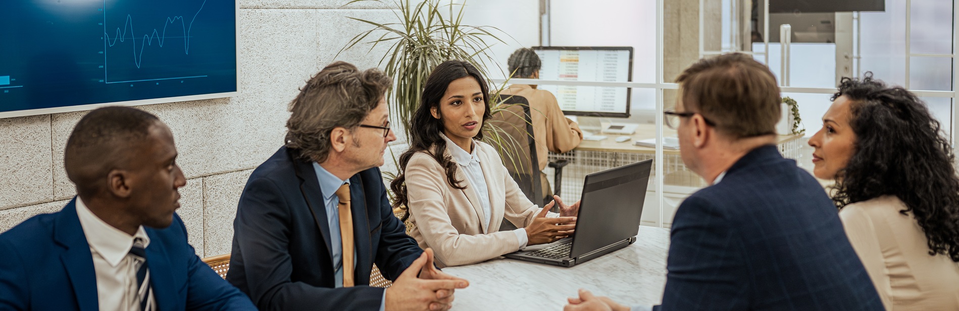 A manager speaks with colleagues in a meeting