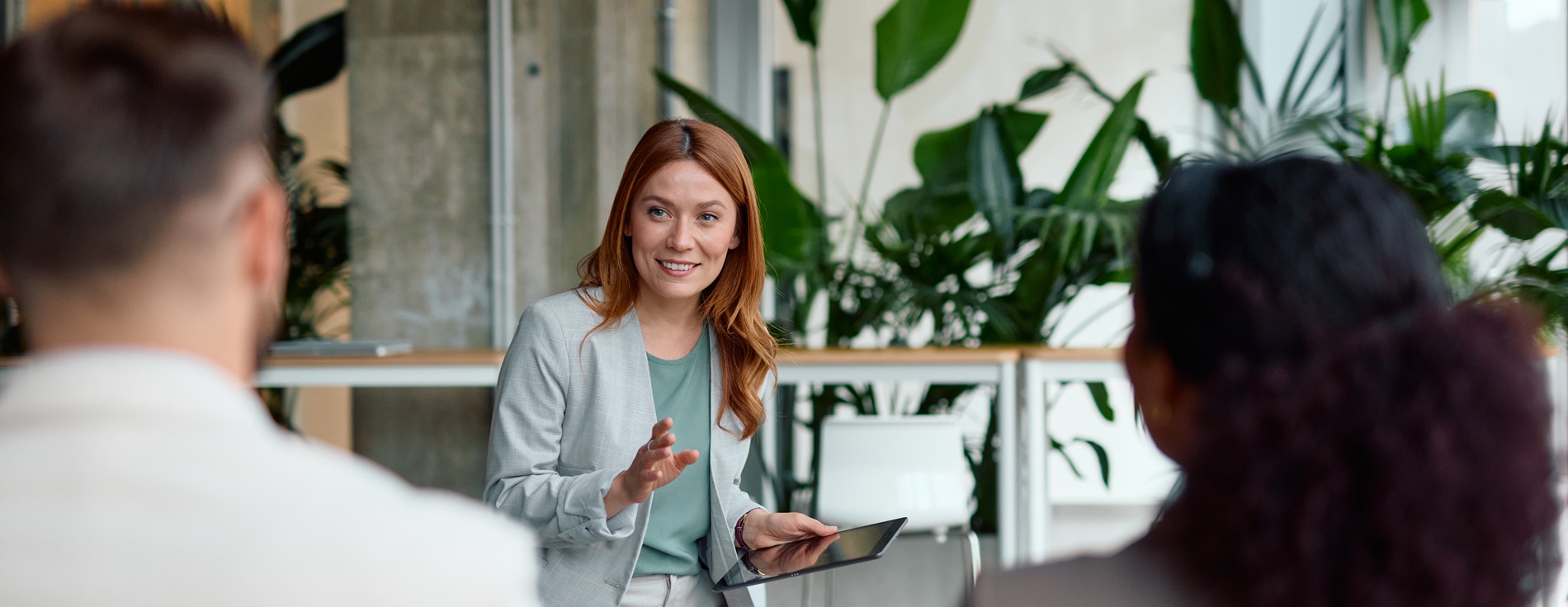 A woman leads a training session in an office.