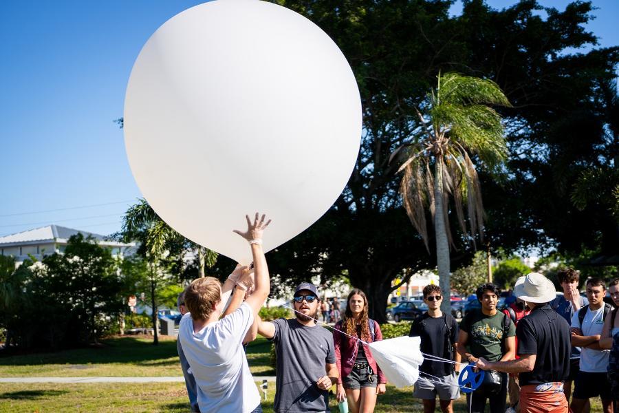 Students prepare to release a weather balloon on campus