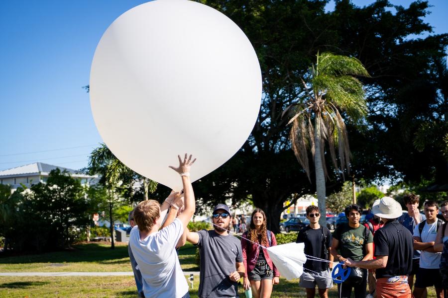 Students prepare to release a weather balloon on campus
