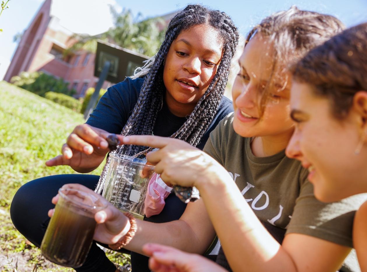 Students taking water samples from a pond
