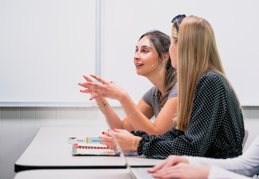 A student gestures during a class discussion.