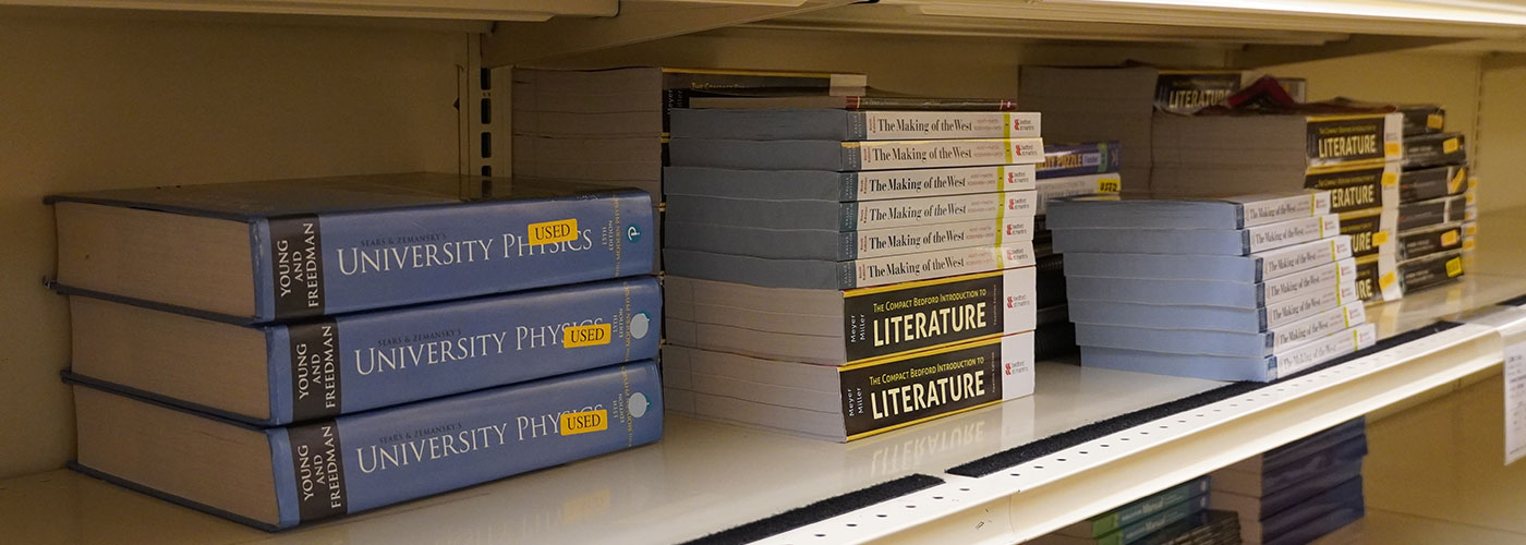 Physics and Literature Textbooks on a store shelf.