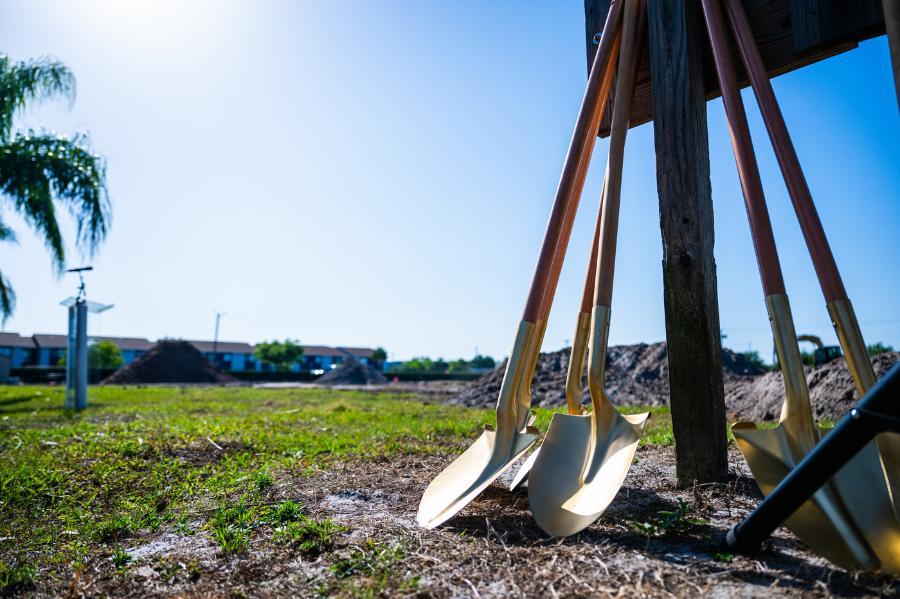 Ceremonial groundbreaking shovels stand ready for use.