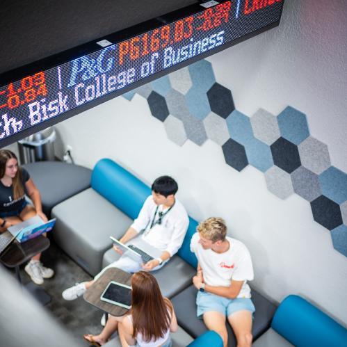 Overhead view of students working in the College of Business lobby