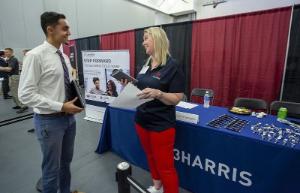 L3Harris recruiter speaking with student at Florida Tech career fair.