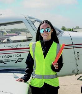 Aviation Student next to plane.