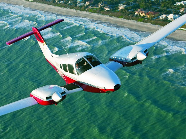 Small plane flying over the ocean