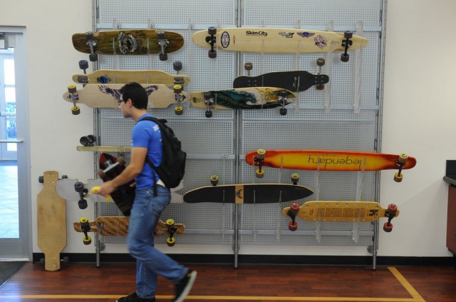 Student walking through a skateboard shop