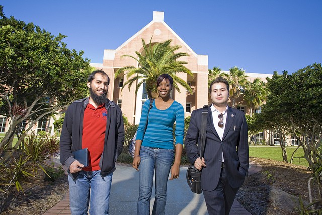Three students standing outside