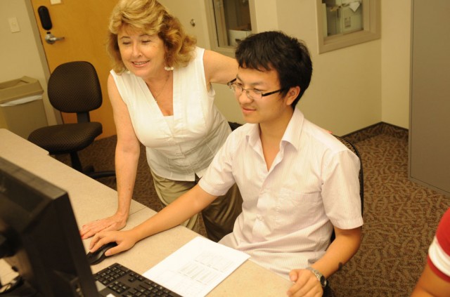 A student being assisted by a professor
