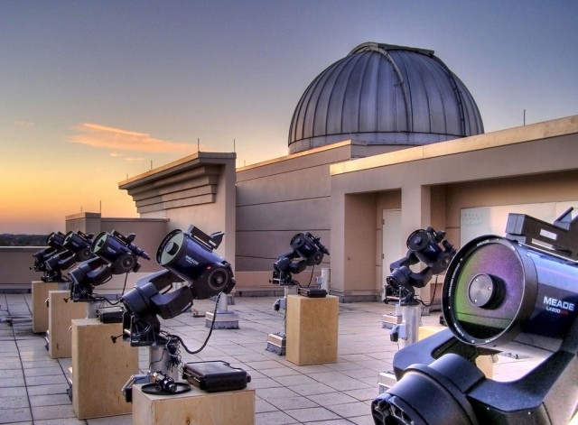 On top of the building at dusk, telescopes ready for use