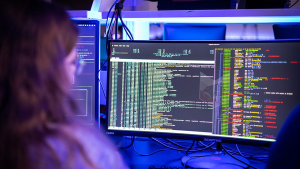 A student viewing screens of computer code