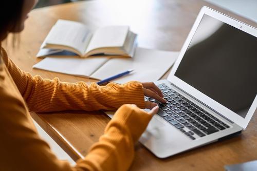 a student sitting at a computer to study