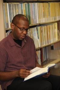 A student reading a book in the library