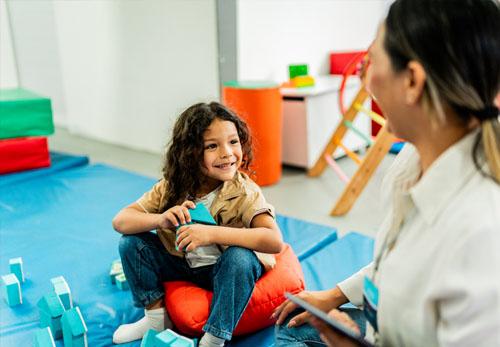 Happy kid with therapist.