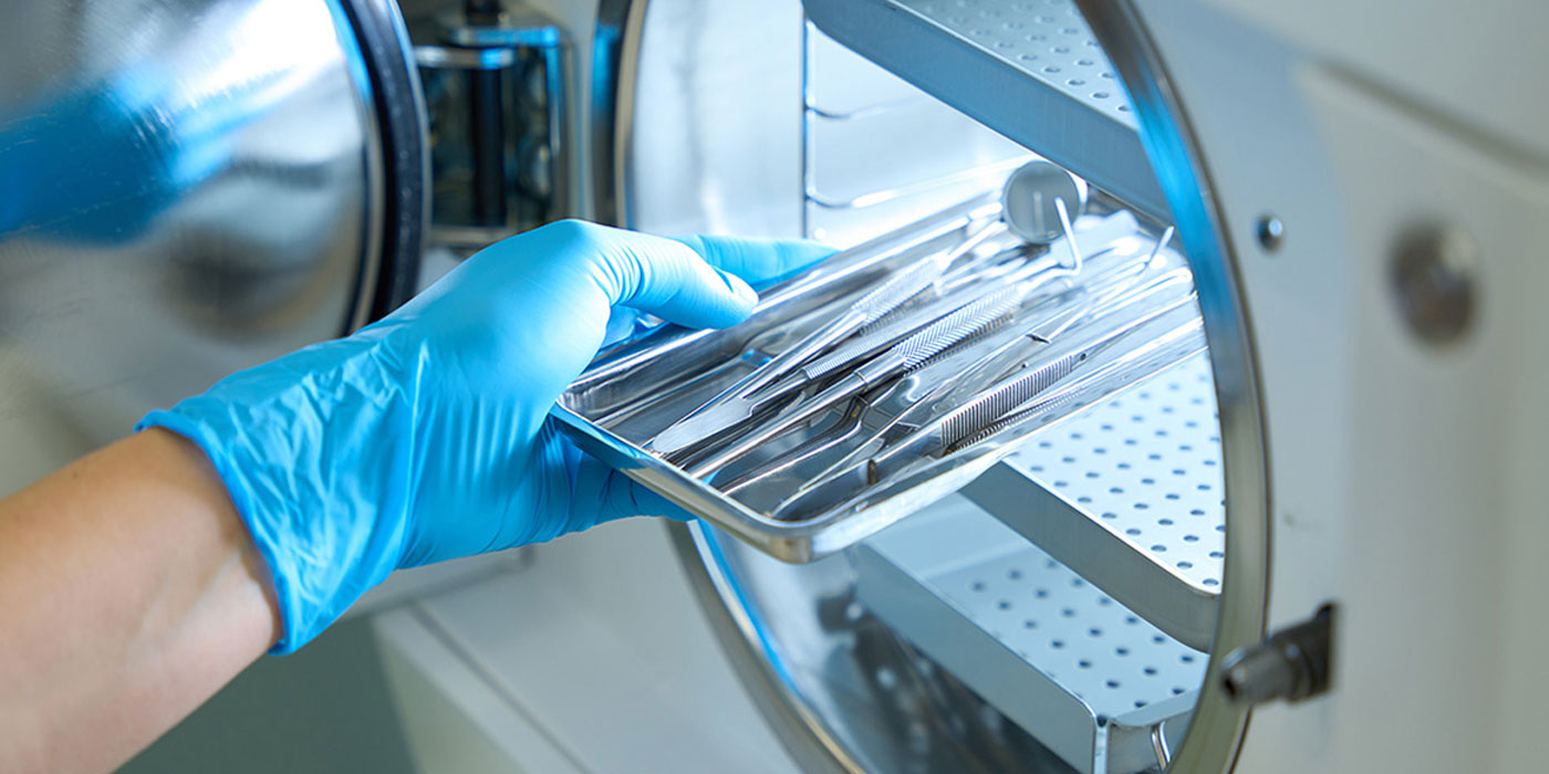 sterilizied processing technician holding medical equipment