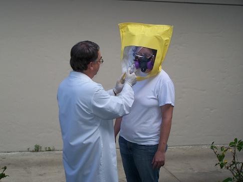Professor spraying the face mask