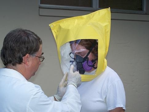 Professor demonstrating a spray on the head gear