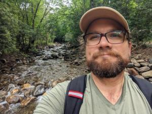 Ed Dunne in front of a bubbling brook