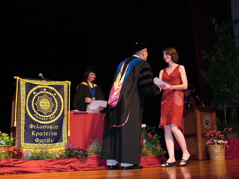 A student receiving her induction certificate