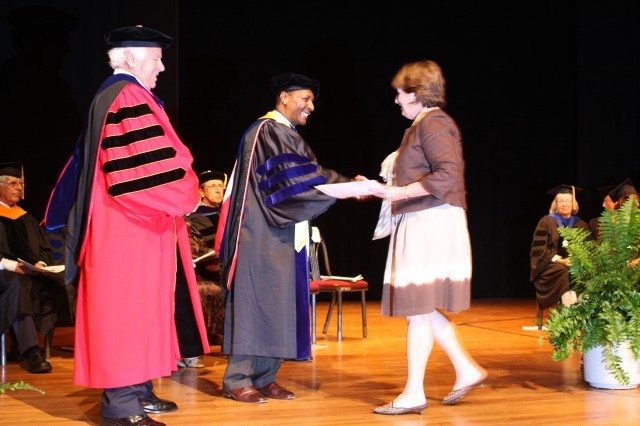 Being congratulated on her certificate