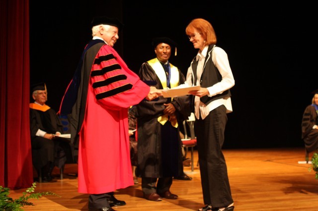 Receiving a handshake after getting her certificate