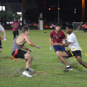 Students attempt to grab the ball carriers flag during an intramural flag football game