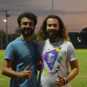 Two student officials smiling and giving thumbs up during an intramural sports competition.