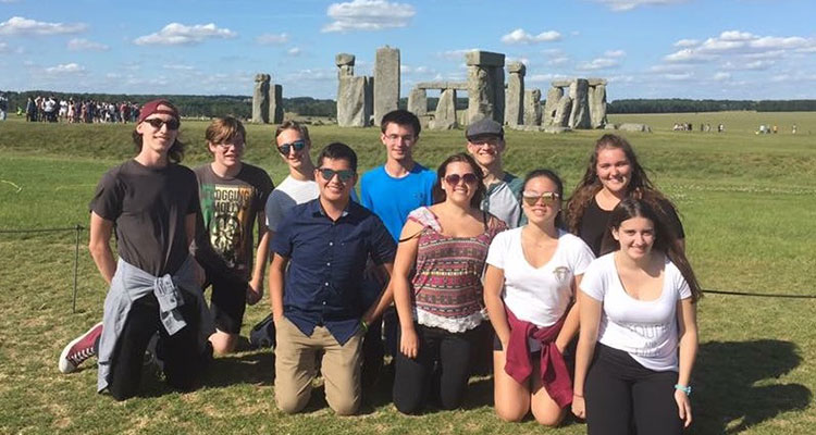 Students posing in front of Stonehenge