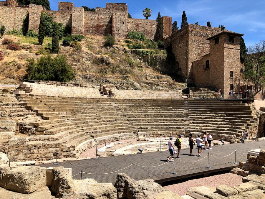 Students walking through a stone theatre